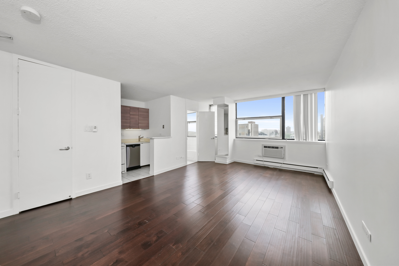3110 North Sheridan Road, Unit 1207 Chicago, IL 60657 - Photo 9 of 32 a view of a kitchen with wooden floor and windows