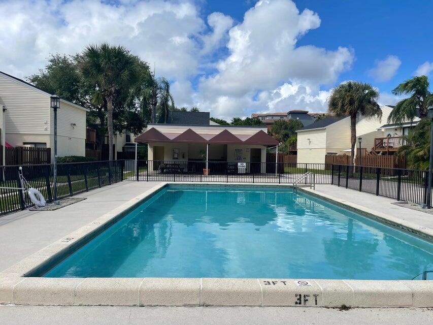 641 Executive Center Drive, Unit P105 West Palm Beach, FL 33401 - Photo 15 of 21 a view of a house with swimming pool