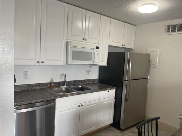 a kitchen with a stove and a clock on the wall