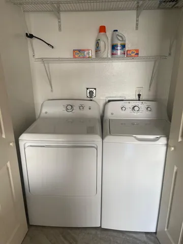 a kitchen with a refrigerator sink and cabinets
