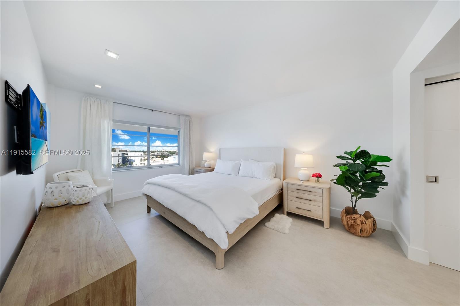 1450 Lincoln Road, Unit 1003 Miami Beach, FL 33139 - Photo 11 of 27 a bedroom with a bed and a flat screen tv
