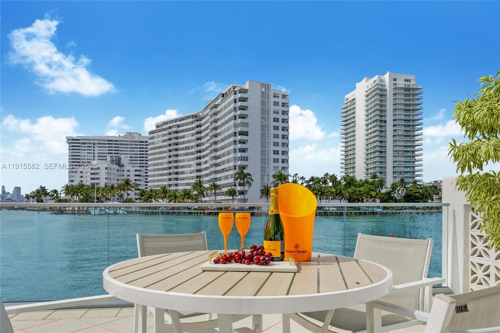 1450 Lincoln Road, Unit 1003 Miami Beach, FL 33139 - Photo 19 of 27 a table and chairs sitting in front of a lake