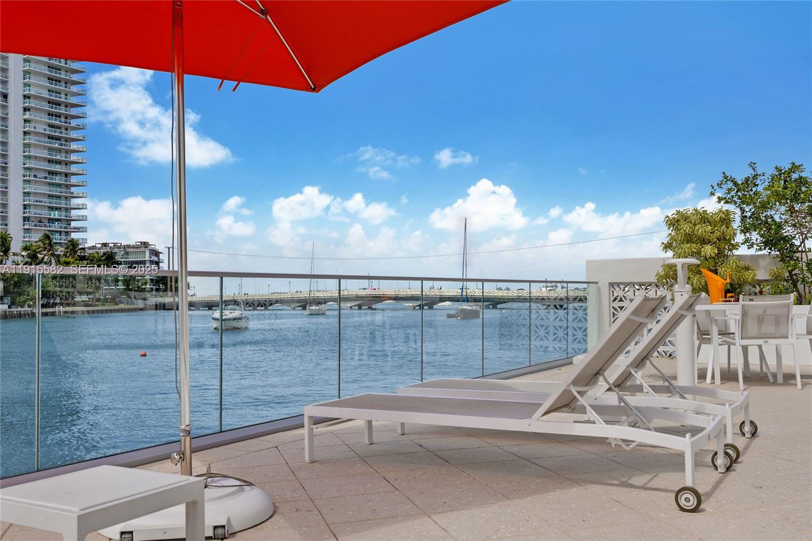 1450 Lincoln Road, Unit 1003 Miami Beach, FL 33139 - Photo 23 of 27 a view of a swimming pool with a chair and tables