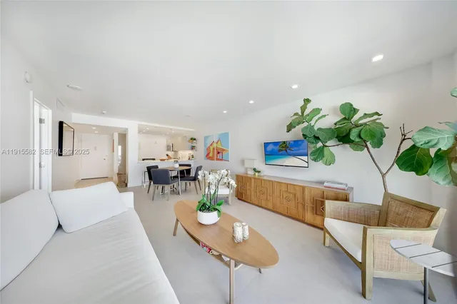 a living room with furniture and a potted plant