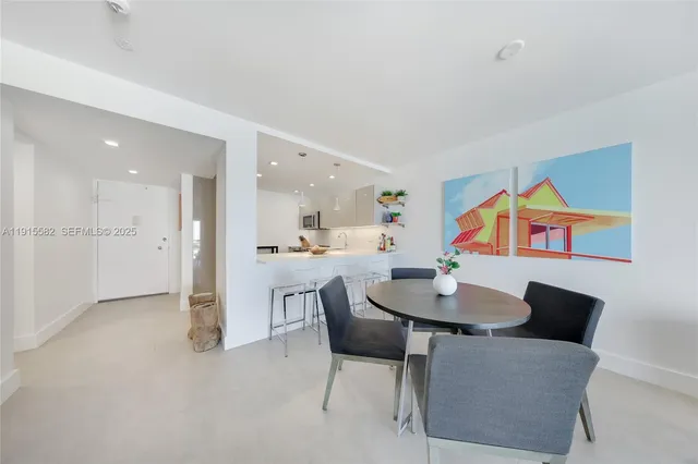 a dining room with furniture and a kitchen view