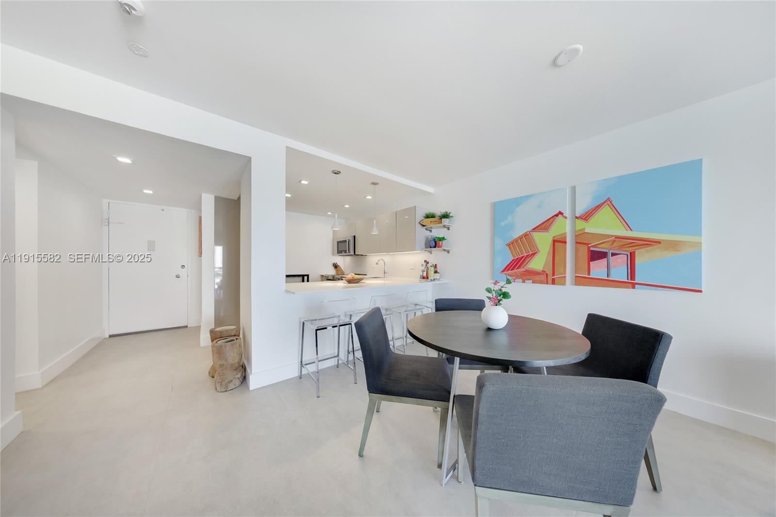 1450 Lincoln Road, Unit 1003 Miami Beach, FL 33139 - Photo 5 of 27 a dining room with furniture and a kitchen view