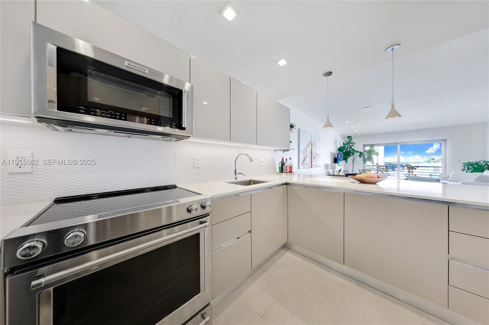 1450 Lincoln Road, Unit 1003 Miami Beach, FL 33139 - Photo 6 of 27 a kitchen with a stove and a microwave