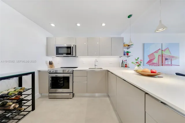 a kitchen with stainless steel appliances a stove sink microwave and cabinets