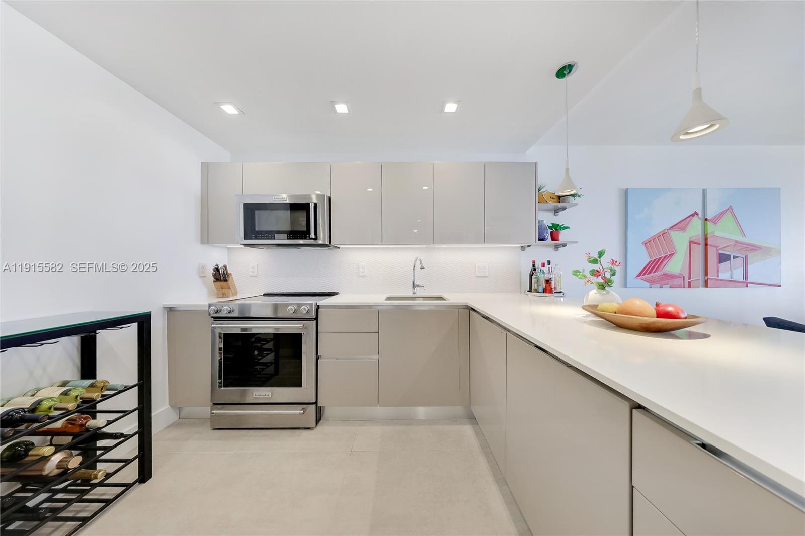 1450 Lincoln Road, Unit 1003 Miami Beach, FL 33139 - Photo 7 of 27 a kitchen with stainless steel appliances a stove sink microwave and cabinets