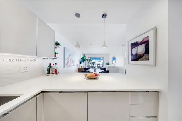 a view of a kitchen with a sink and cabinets