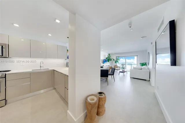 a view of living room kitchen with furniture and a potted plant