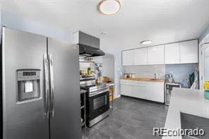 a kitchen with a refrigerator and a sink
