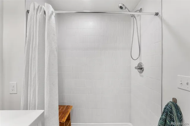 a bathroom with a shower curtain and a shower
