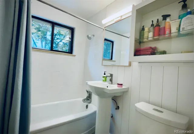 a bathroom with a sink mirror toilet and bathtub