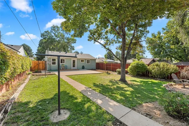 a house view with swimming pool and garden