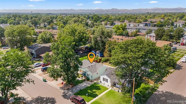 an aerial view of a house with a yard and lake view