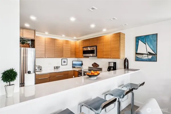 a large kitchen with a table and chairs
