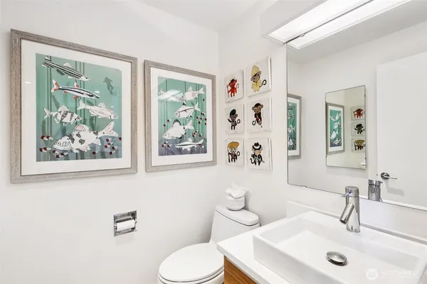 a bathroom with a sink mirror and toilet