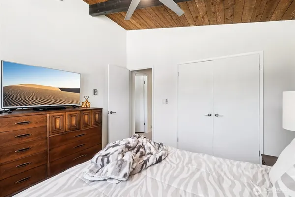 a bedroom with a bed and a dresser