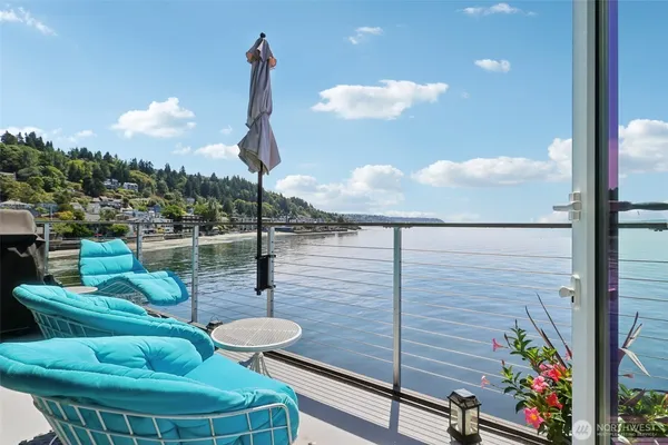a view of a balcony with chair and tables