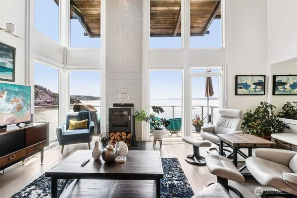 a living room with fireplace furniture and a potted plant