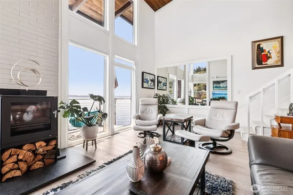a living room with furniture fireplace and wooden floor
