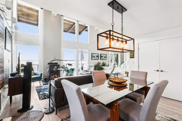 a dining room with furniture a chandelier and window