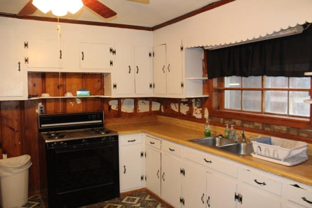 436 Smartt Station Road Morrison, TN 37357 - Photo 8 of 13 a kitchen with granite countertop a stove a sink and a microwave