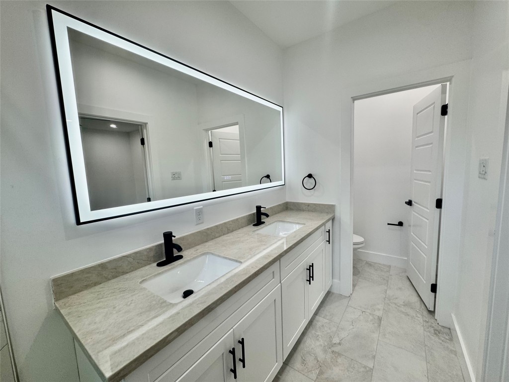 6928 Paris Street, Unit B Houston, TX 77021 - Photo 13 of 20 a bathroom with a granite countertop sink mirror and toilet