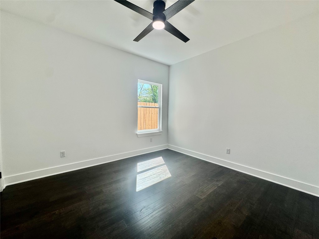 6928 Paris Street, Unit B Houston, TX 77021 - Photo 15 of 20 an empty room with wooden floor and windows