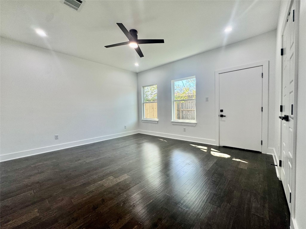 6928 Paris Street, Unit B Houston, TX 77021 - Photo 10 of 20 an empty room with wooden floor and windows