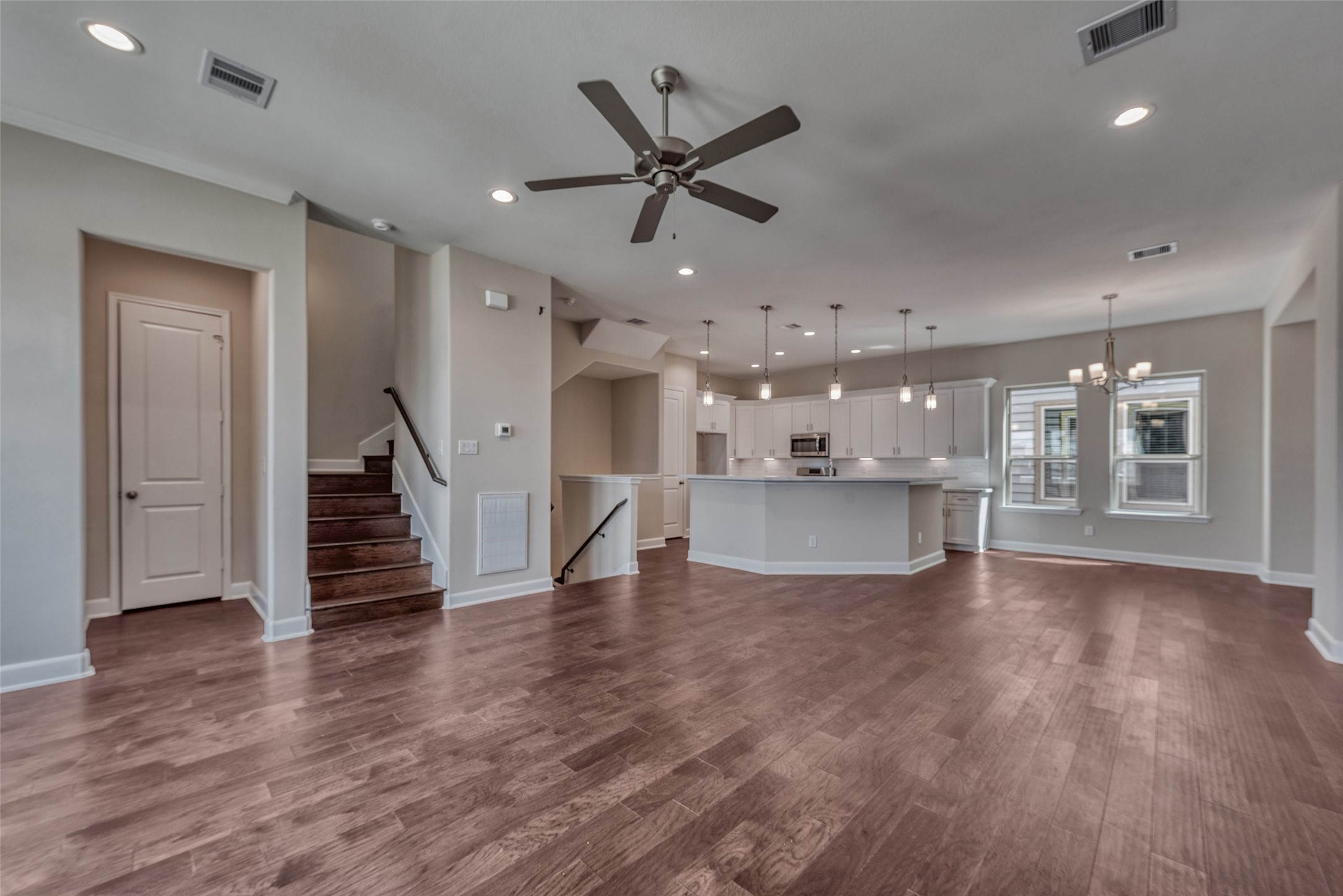 4135 Du Pont Street Houston, TX 77021 - Photo 3 of 30 a view of an empty room with wooden floor and a ceiling fan