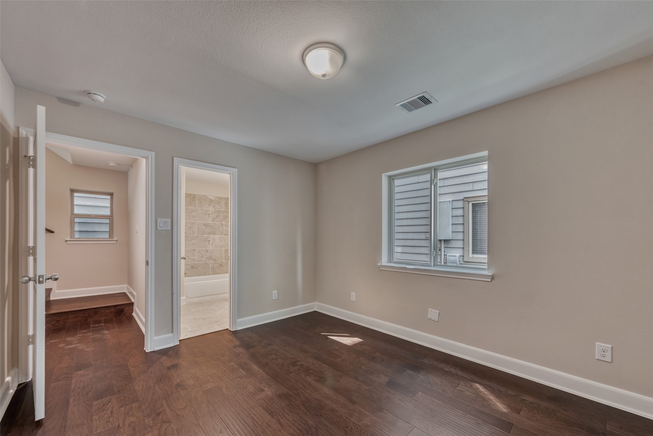 4135 Du Pont Street Houston, TX 77021 - Photo 8 of 30 an empty room with wooden floor and windows