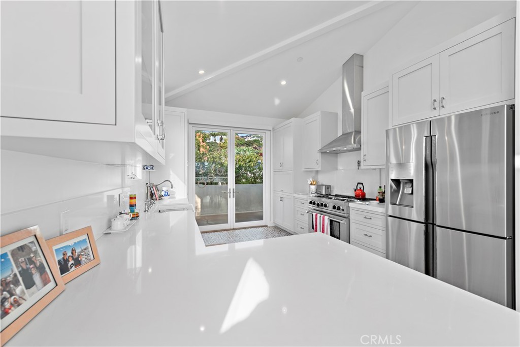 219 Emerald Bay Laguna Beach, CA 92651 - Photo 13 of 52 a kitchen with granite countertop a refrigerator and a sink