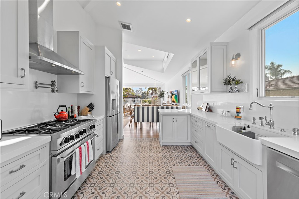219 Emerald Bay Laguna Beach, CA 92651 - Photo 16 of 52 a kitchen with a sink and a stove top oven