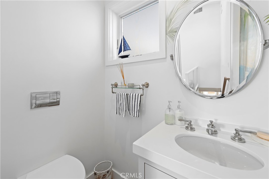 219 Emerald Bay Laguna Beach, CA 92651 - Photo 22 of 52 a bathroom with a sink mirror and toilet