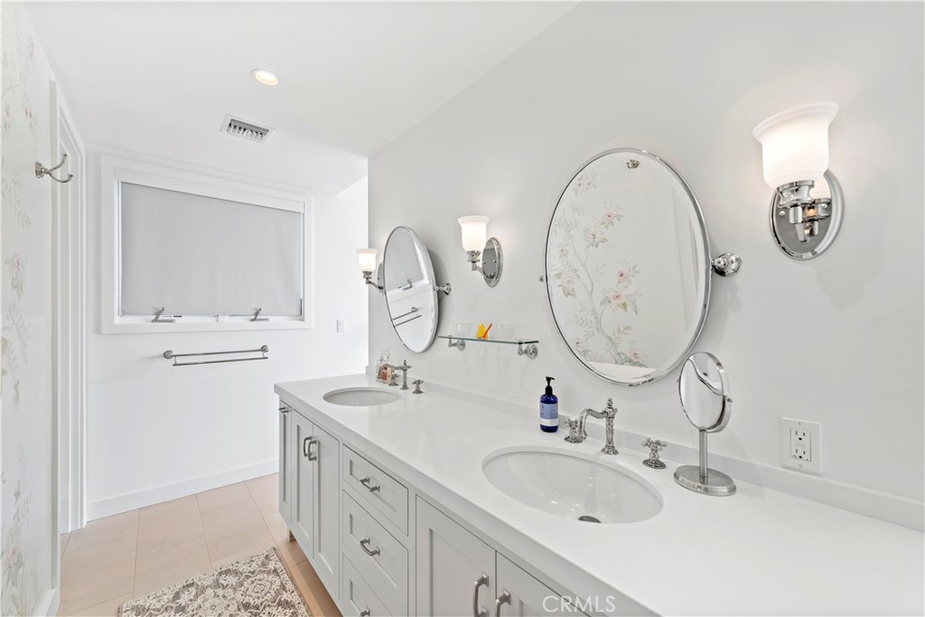 219 Emerald Bay Laguna Beach, CA 92651 - Photo 30 of 52 a bathroom with a double vanity sink and a mirror