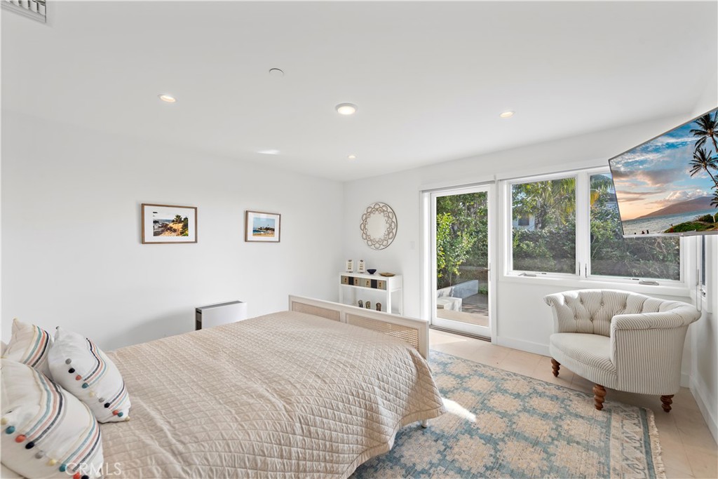 219 Emerald Bay Laguna Beach, CA 92651 - Photo 38 of 52 a spacious bedroom with a large bed and a large window