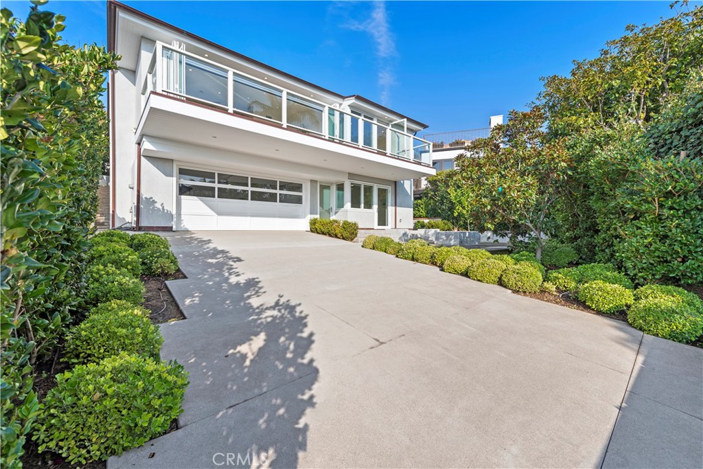 219 Emerald Bay Laguna Beach, CA 92651 - Photo 45 of 52 a front view of a house with a yard and potted plants