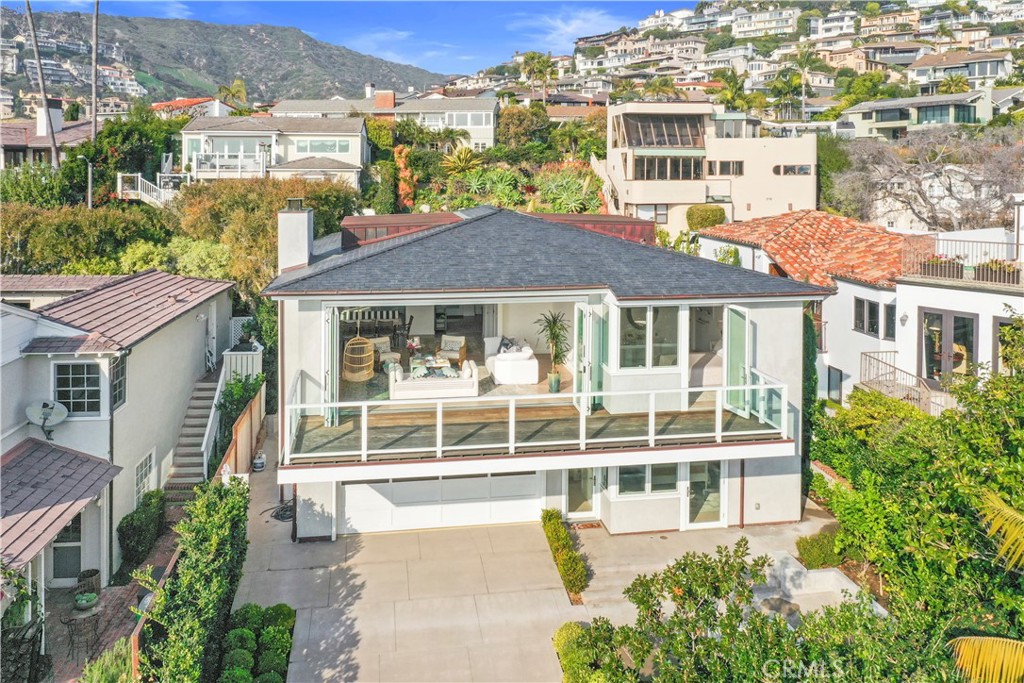 219 Emerald Bay Laguna Beach, CA 92651 - Photo 49 of 52 a front view of a residential apartment building with a yard