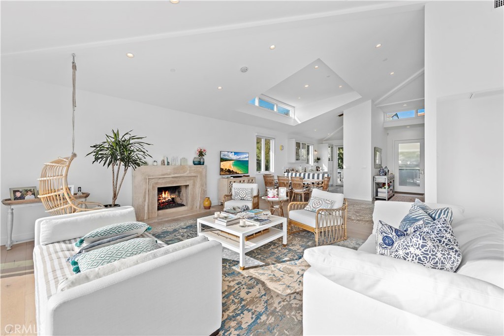 219 Emerald Bay Laguna Beach, CA 92651 - Photo 6 of 52 a living room with furniture a fireplace and a potted plant