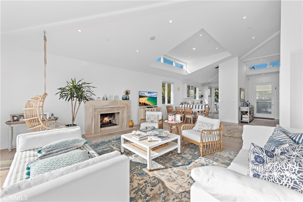219 Emerald Bay Laguna Beach, CA 92651 - Photo 7 of 52 a living room with furniture a fireplace and a table
