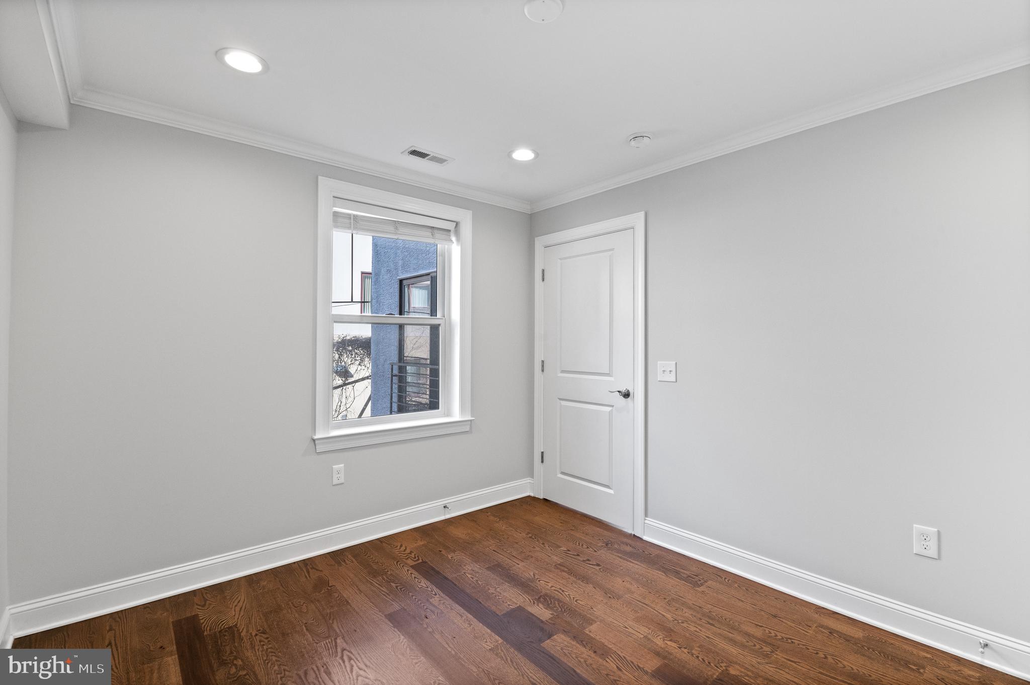 988 North Marshall Street, Unit 2R Philadelphia, PA 19123 - Photo 22 of 29 a view of an empty room with wooden floor and a window