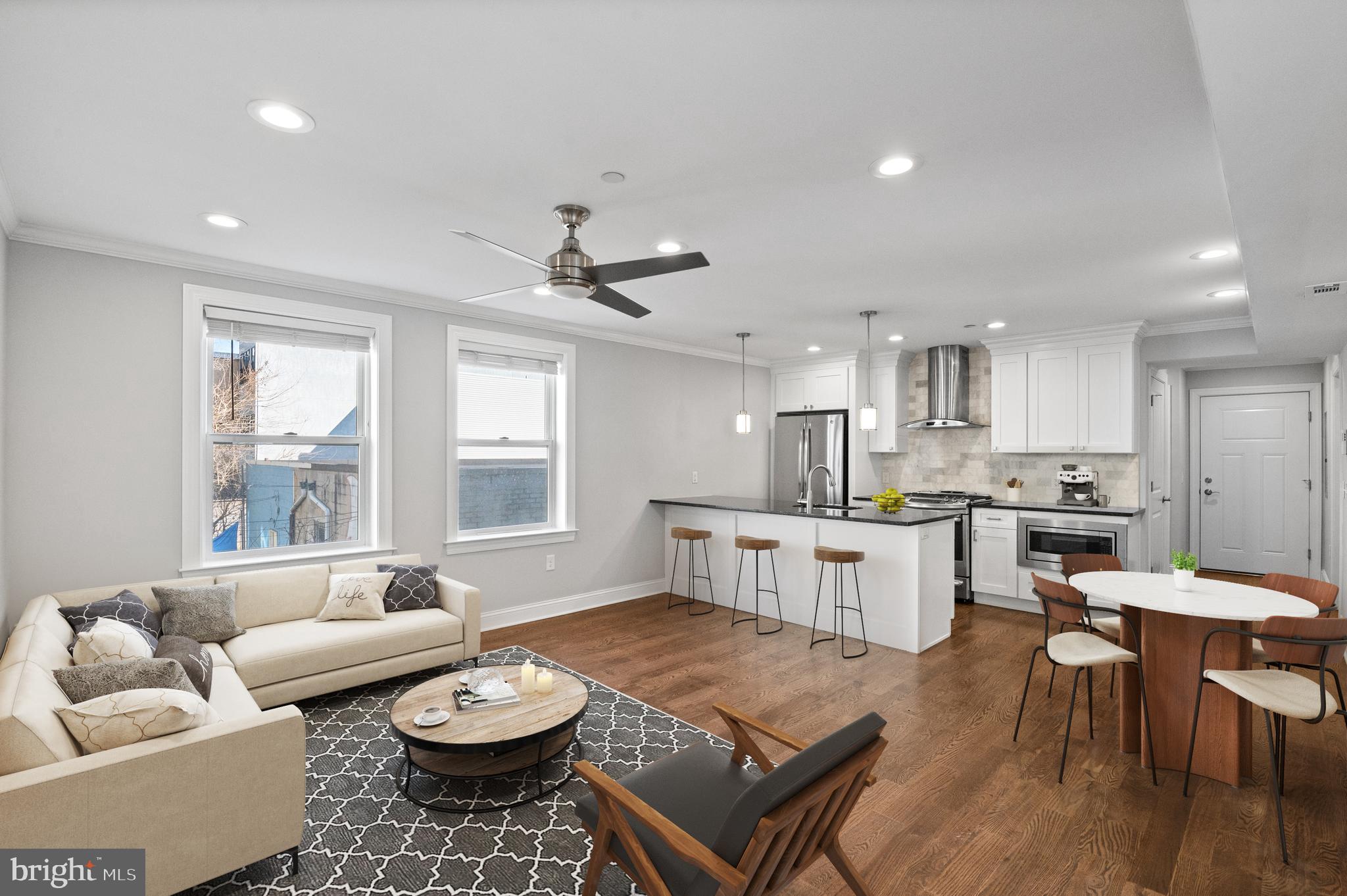 988 North Marshall Street, Unit 2R Philadelphia, PA 19123 - Photo 4 of 29 a living room with stainless steel appliances kitchen island granite countertop a couch and a dining table with kitchen view