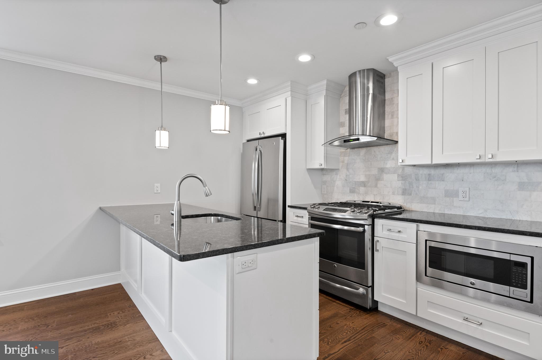 988 North Marshall Street, Unit 2R Philadelphia, PA 19123 - Photo 7 of 29 a kitchen with stainless steel appliances granite countertop a stove a sink and a refrigerator