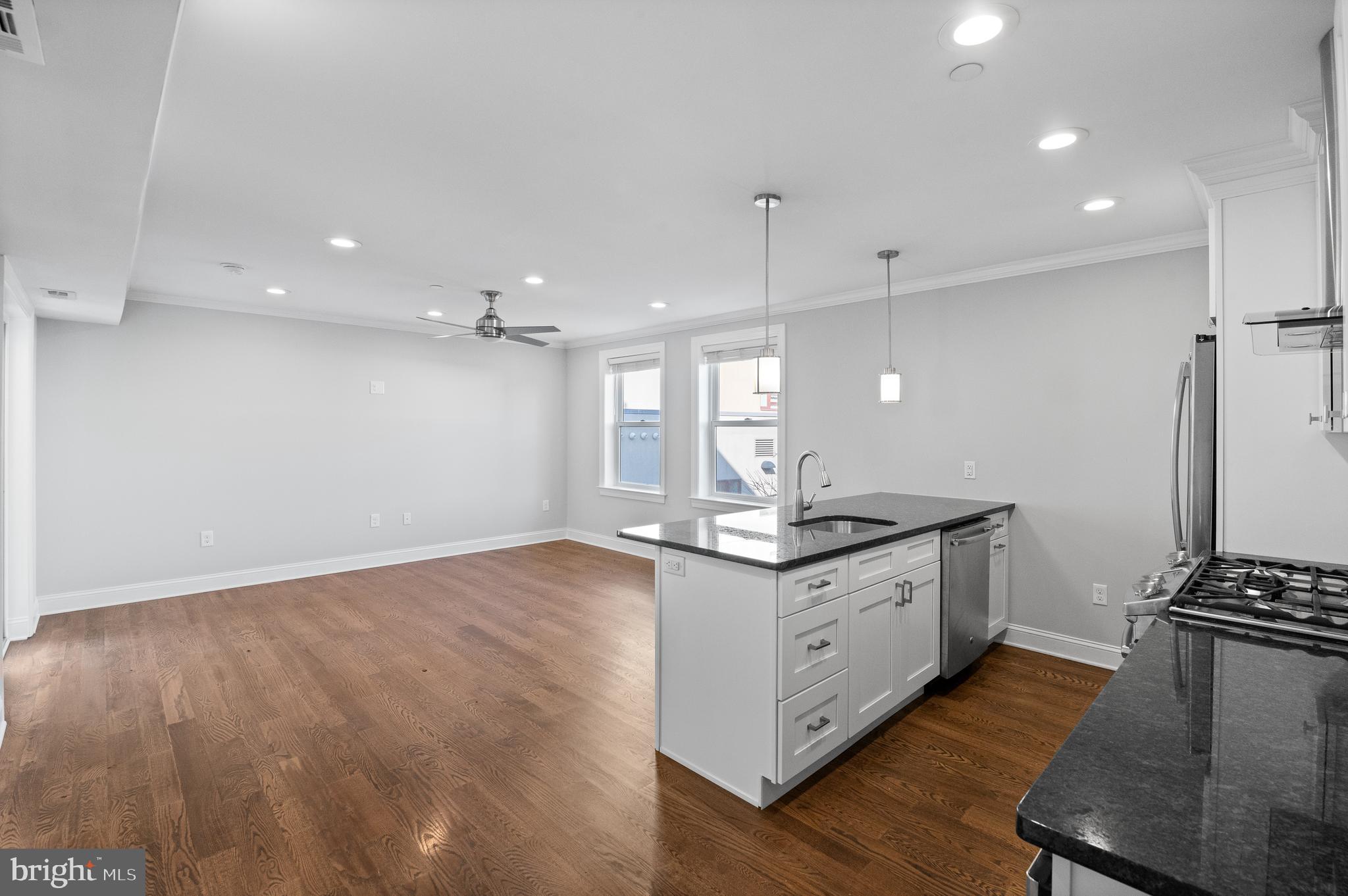 988 North Marshall Street, Unit 2R Philadelphia, PA 19123 - Photo 8 of 29 a kitchen with granite countertop a sink appliances and cabinets