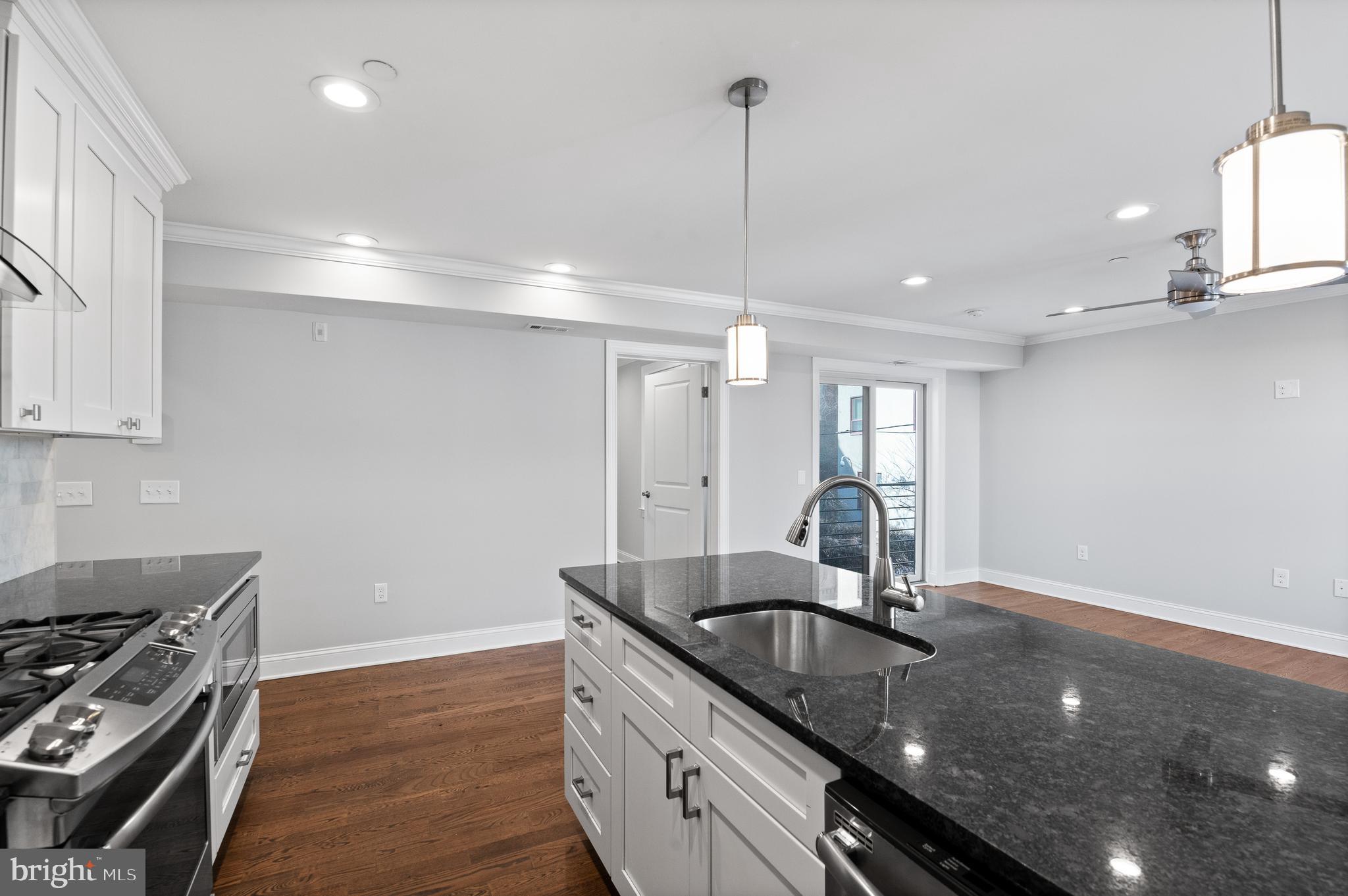 988 North Marshall Street, Unit 2R Philadelphia, PA 19123 - Photo 10 of 29 a kitchen with granite countertop a sink stainless steel appliances and cabinets