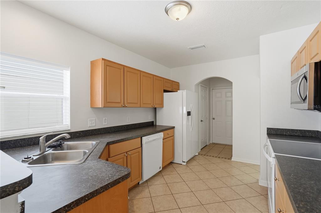 4155 Day Bridge Place Ellenton, FL 34222 - Photo 20 of 42 a kitchen with granite countertop a sink and a stove