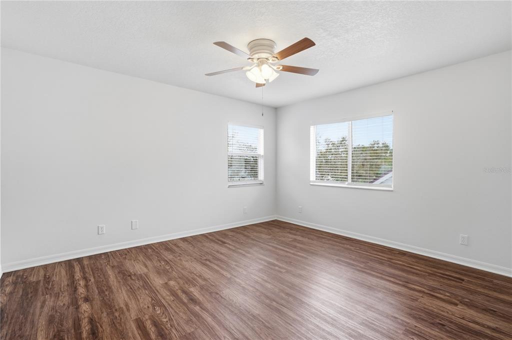 4155 Day Bridge Place Ellenton, FL 34222 - Photo 25 of 42 an empty room with wooden floor and windows