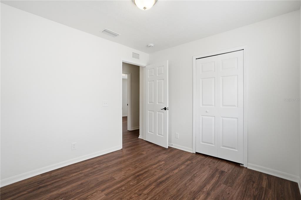 4155 Day Bridge Place Ellenton, FL 34222 - Photo 29 of 42 a view of an empty room with wooden floor